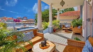 an outdoor patio with a pool and a house at Atelier Skalo Boutique Hotel in Willemstad