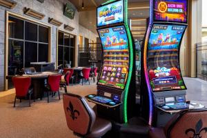 two video game machines in a room with tables at Nobu Hotel New Orleans - A Caesars Rewards Destination in New Orleans