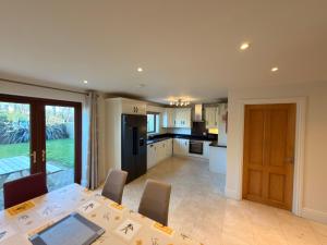 a kitchen and dining room with a table and chairs at Cois Cairn in Dingle