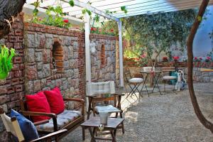 a brick wall with a couch and a table at Losta Sahil Evi 2 in Selimiye