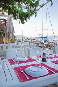 a white table with red napkins and utensils on top of a table at Losta Sahil Evi 2 in Selimiye
