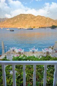 a view of a body of water with tables and chairs at Losta Sahil Evi 2 in Selimiye