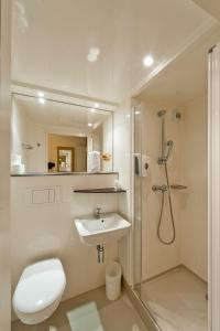 a bathroom with a shower and a toilet and a sink at Premiere Classe Sens Nord- Saint Clément in Sens