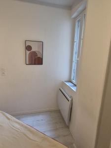 a room with a bed and a window at Le Cocon de la Cathédrale au cœur de Metz in Metz
