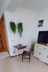 a room with a table and a tv and a chair at VistaBellaBorromeoFlat in Baveno +24 photos