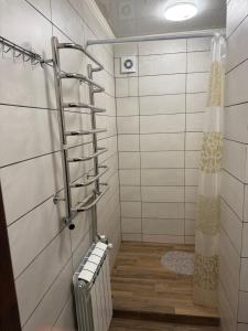 a bathroom with a shower with a towel rack at Краєвид in Vorokhta +62 photos