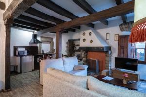 a living room with a couch and a fireplace at Apartaments Can Lo in Rupit