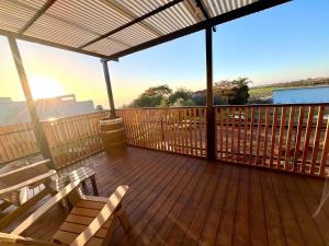 a deck with benches and a view of the mountains at Cabin 168 in Neot Golan