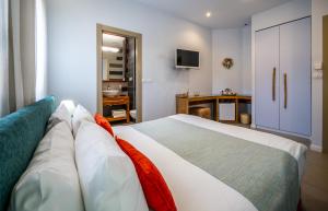 a bedroom with a large bed and a bathroom at Bat Galim Boutique Hotel in Haifa