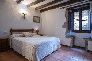a bedroom with a bed and a cross on the wall at Apartaments Can Lo in Rupit
