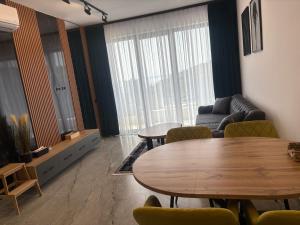 a living room with two tables and a couch at Rezidenca Onda in Lezhë +8 photos