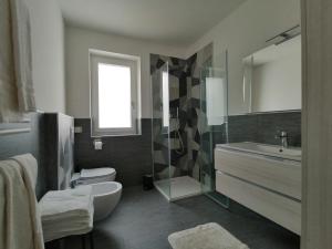 a bathroom with a sink toilet and a shower at Superior Apartments Giovannini in Fai della Paganella +31 photos