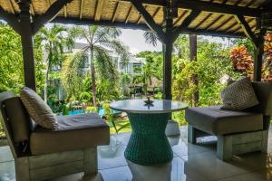 a patio with a table and two chairs at Mondo Surf Village in Canggu