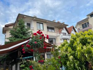 a building with flowers on the front of it at kaLe in Ravda