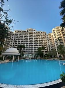 a large swimming pool in front of a large building at 2BR Seaview Condo with Balcony, Riviera Bay Resort Melaka in Malacca
