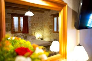 a reflection of a bedroom with a bed in a mirror at Villa Belvedere - Panoramic Sea View apts in Vasilikos
