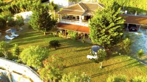 an aerial view of a large house with trees at Villa Belvedere - Panoramic Sea View apts in Vasilikos