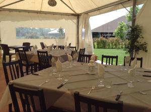 a set of tables in a tent with glasses at La Scuderia in Sarzana +22 photos