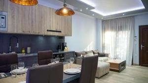 a kitchen and living room with a table and a couch at P & K Design LTD Flats in Nea Moudania
