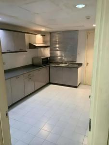 a kitchen with stainless steel appliances and a white tile floor at 2BR Seaview Condo with Balcony, Riviera Bay Resort Melaka in Malacca