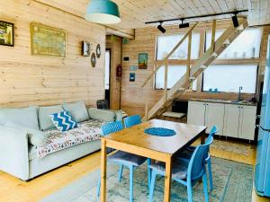 a living room with a table and a couch at Park & Beach House in Ureki Magnetiti, Sleeps 6 in Ureki