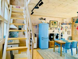 a staircase in a room with a table and a kitchen at Park & Beach House in Ureki Magnetiti, Sleeps 6 in Ureki