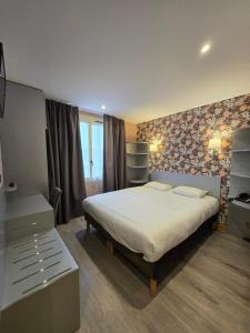 a bedroom with a large bed in a room at Beaune Hôtel in Beaune +47 photos
