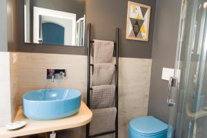 a bathroom with a blue sink and a shower at Matinee Rooms in Mattinata +127 photos