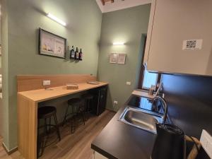 a kitchen with a sink and a counter with stools at Il Podere Orto in San Gimignano +16 photos