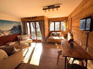 a living room with a couch and a table at Studio Piccola Renna in Limone Piemonte