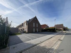 a large brick building on a street at mein Urlaubshafen - Anleger I oder II in Carolinensiel