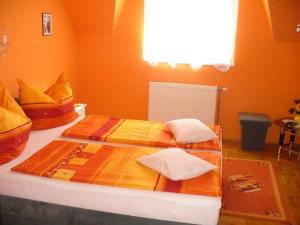 A bed or beds in a room at Caty Vendégház