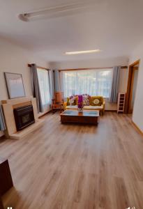 a living room with a couch and a fireplace at Auckland Airport Guest House in Auckland