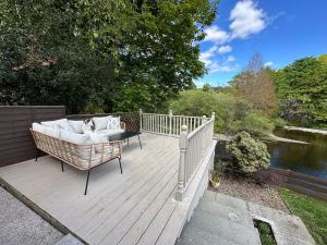 a wooden deck with a couch sitting on top of it at Riverview House in Minnigaff