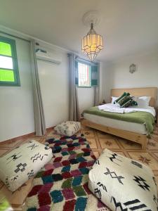 a bedroom with a bed and two pillows on the floor at Riad R Art in Marrakesh