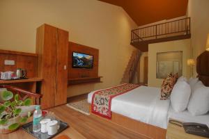 a hotel room with a bed and a television at Royal Hotel Gangtok in Gangtok