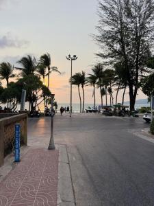 a street with palm trees and a street light at Patong Beach Verve in Patong Beach +16 photos
