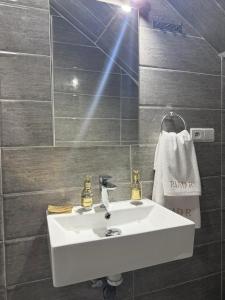 a bathroom with a white sink and a mirror at Riad R Art in Marrakesh +31 photos