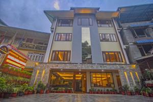 a large building with a lot of windows at Royal Hotel Gangtok in Gangtok