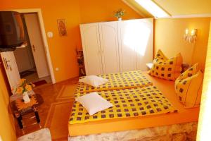 A bed or beds in a room at Caty Vendégház