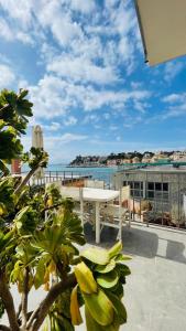 a patio with a table and a view of the ocean at Comodissimo Gaslini e mare in Genoa