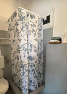 a shower curtain in a bathroom with a toilet at Armeos Blue in Myrties