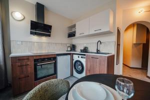 a kitchen with a sink and a dishwasher at Studio Arclusaz by ExplorHome in Albertville +4 photos