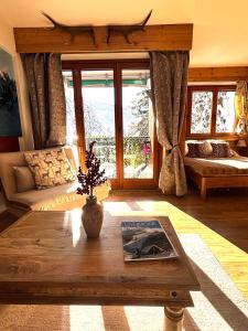 a living room with a couch and a table at Studio Piccola Renna in Limone Piemonte