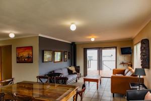 a living room with a couch and a table at Bona Vista in Pringle Bay