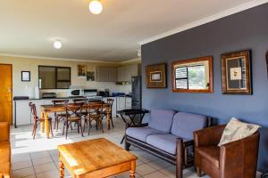 a living room with a couch and a table at Bona Vista in Pringle Bay