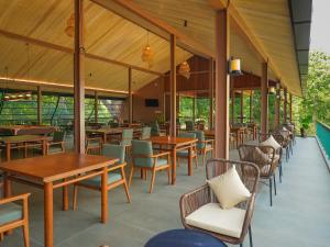 a restaurant with wooden tables and chairs at Ella Planters Bungalow in Ella