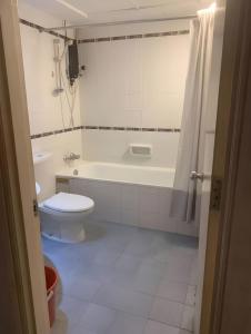 a bathroom with a toilet and a tub and a sink at 2BR Seaview Condo with Balcony at Riviera Bay Resort, Melaka in Malacca