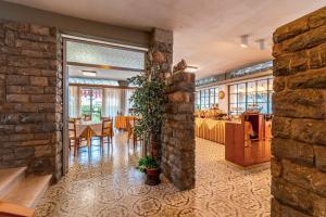 a restaurant with a brick wall and tables and chairs at Hotel Matilde in Marina di Massa