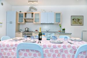 a table with a bottle of wine on it in a kitchen at Villaggio dei Fiori in Caorle